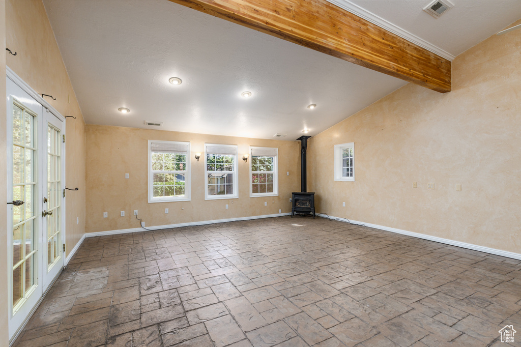 Empty room with baseboards and a wood stove