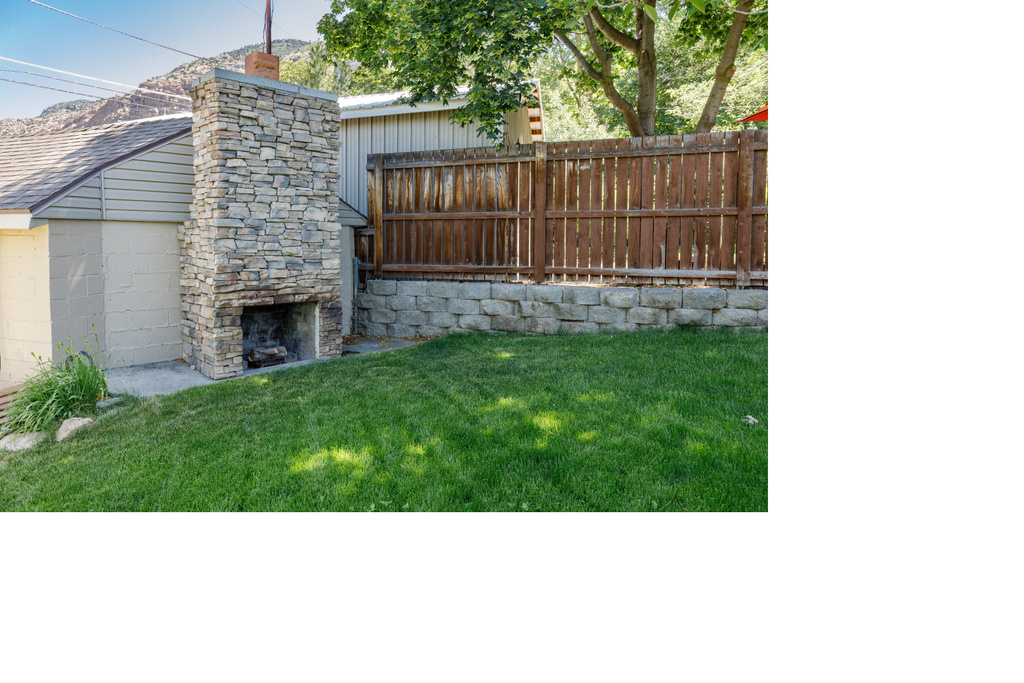 View of yard with a fireplace