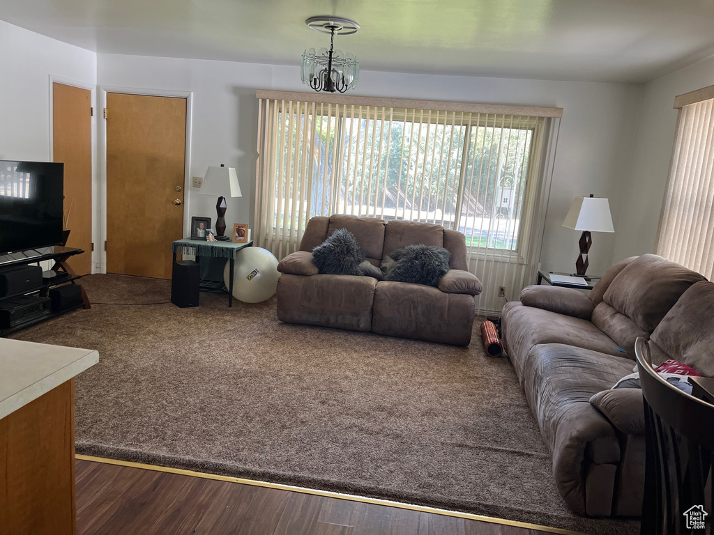 Living area featuring wood finished floors and a chandelier