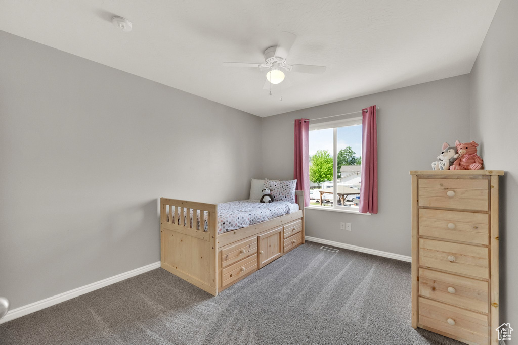 Bedroom featuring dark colored carpet and ceiling fan