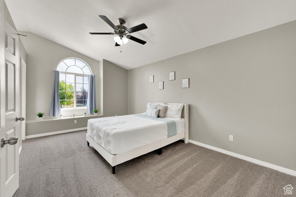 Bedroom featuring carpet flooring, lofted ceiling, and ceiling fan