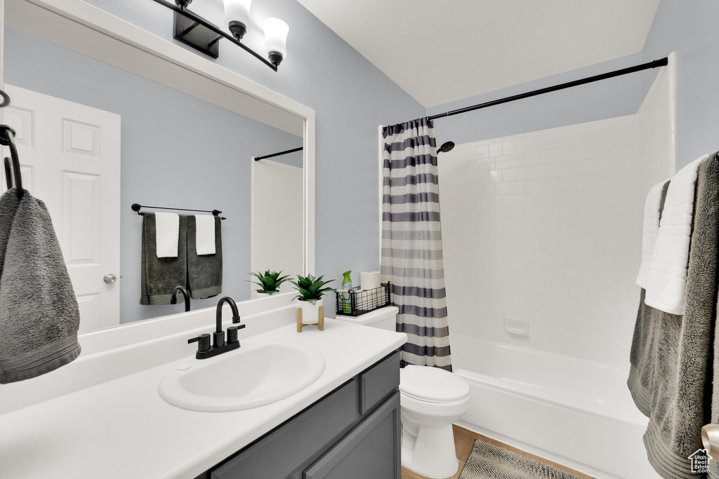 Full bath featuring vanity and shower / bath combination with curtain