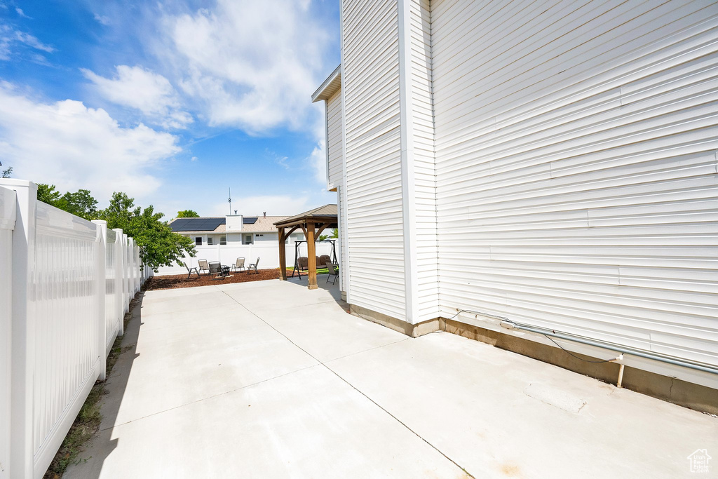Fenced backyard with a gazebo and a patio
