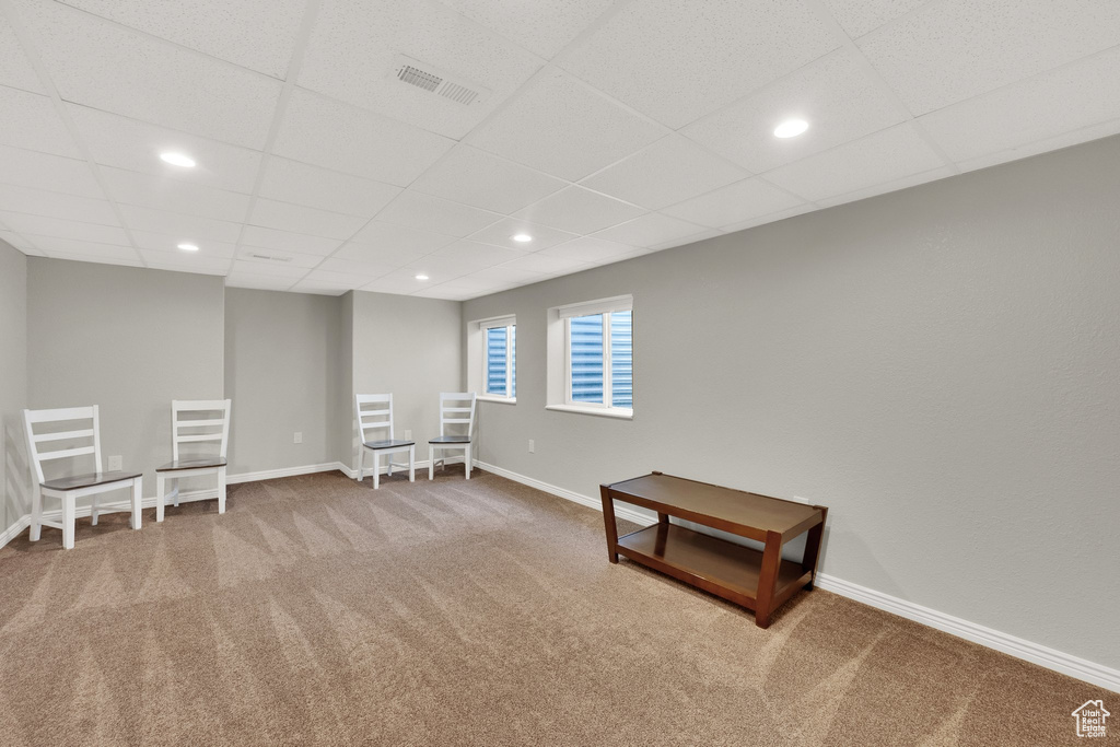 Empty room with carpet, a drop ceiling, and recessed lighting