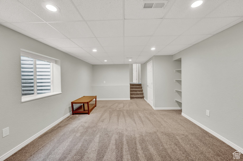 Basement with stairway, carpet flooring, recessed lighting, and a drop ceiling