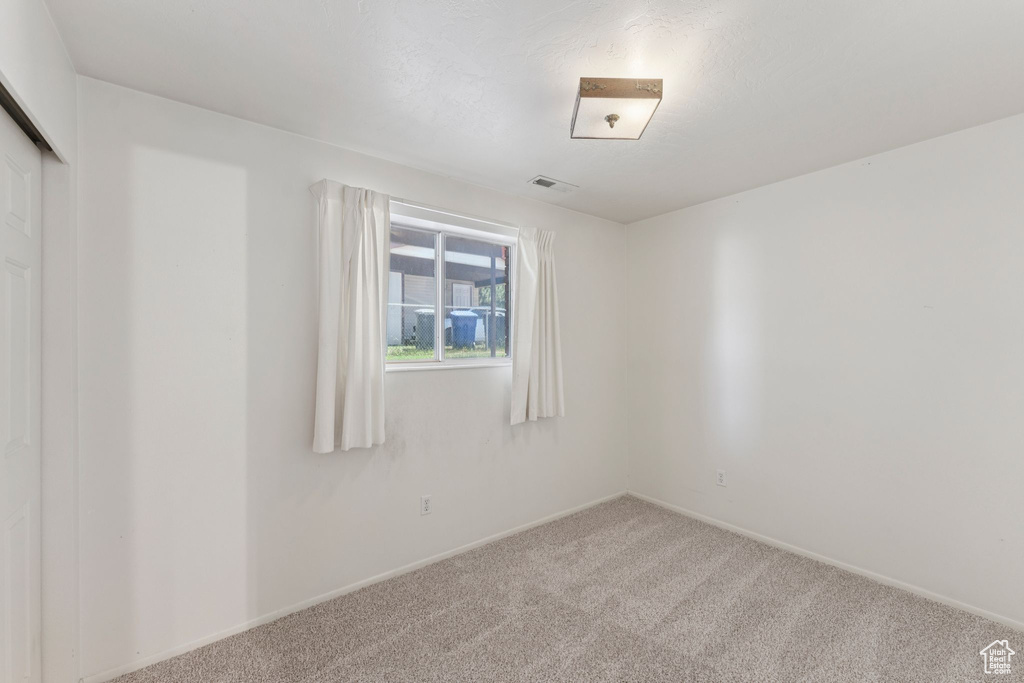 Unfurnished room featuring carpet floors and baseboards