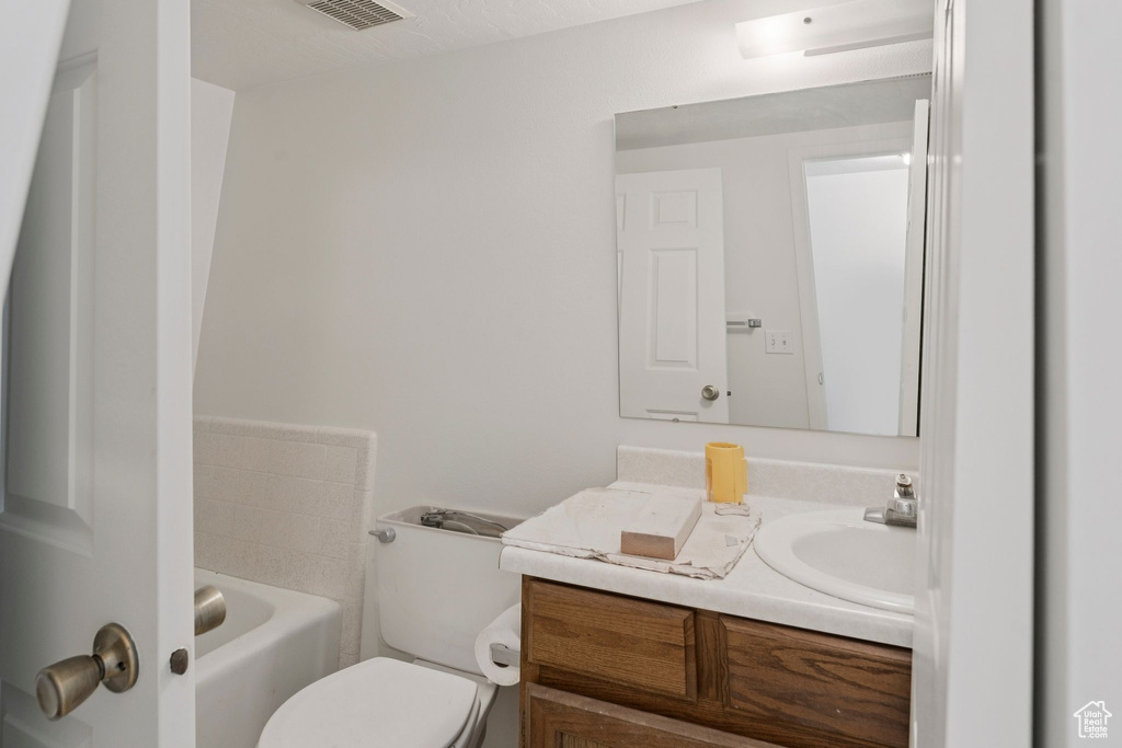 Full bath with vanity and a bathtub