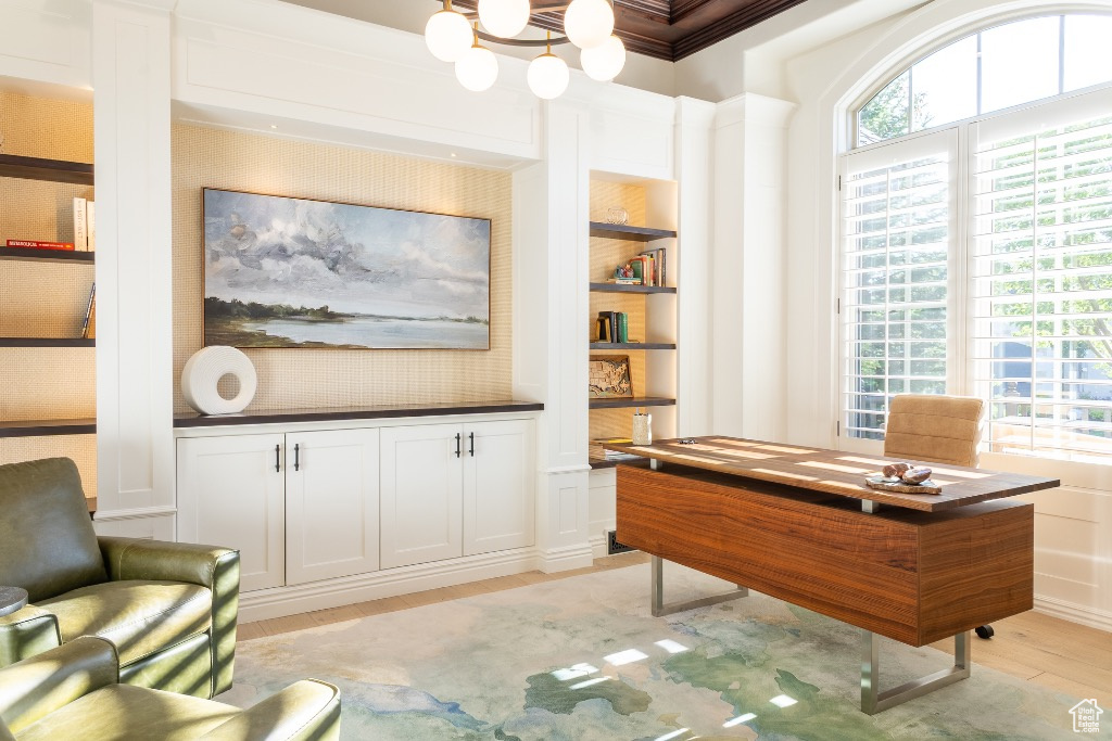 Office featuring light wood-style flooring, ornamental molding, and a chandelier