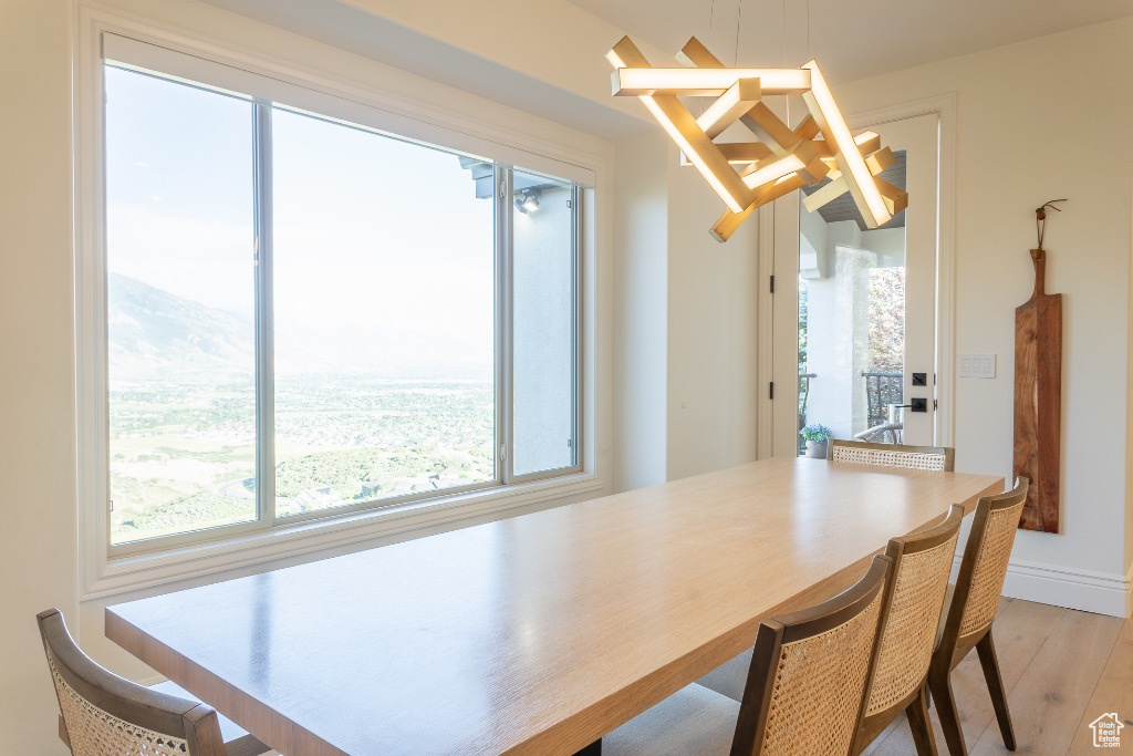 Dining space with plenty of natural light and light wood finished floors