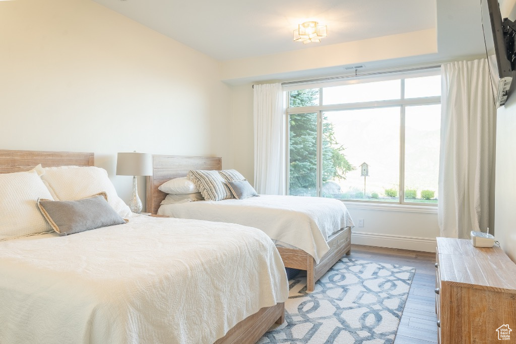 Bedroom featuring multiple windows and light wood finished floors
