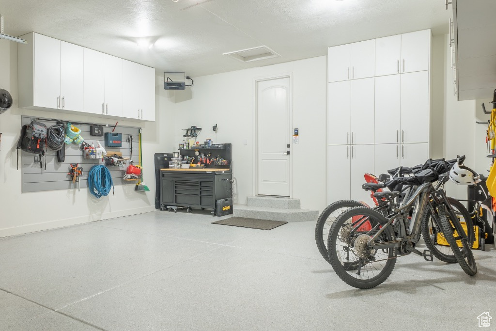 Garage with a workshop area and baseboards