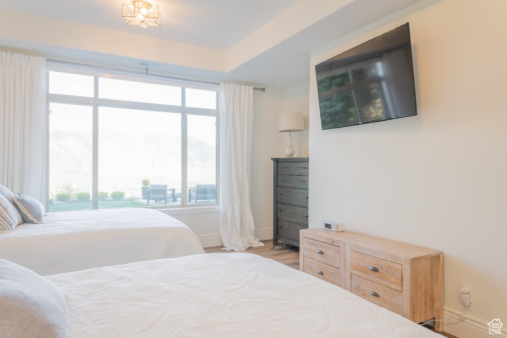 Bedroom featuring baseboards and wood finished floors