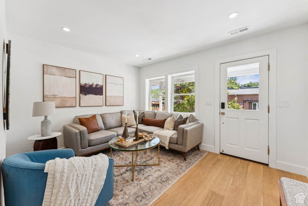 Living room featuring light wood-style floors and recessed lighting