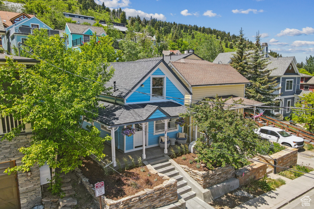 View of front of property with roof with shingles