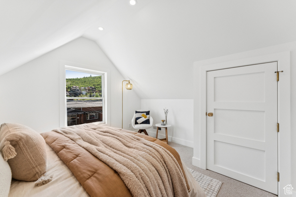 Bedroom with light carpet, lofted ceiling, and recessed lighting