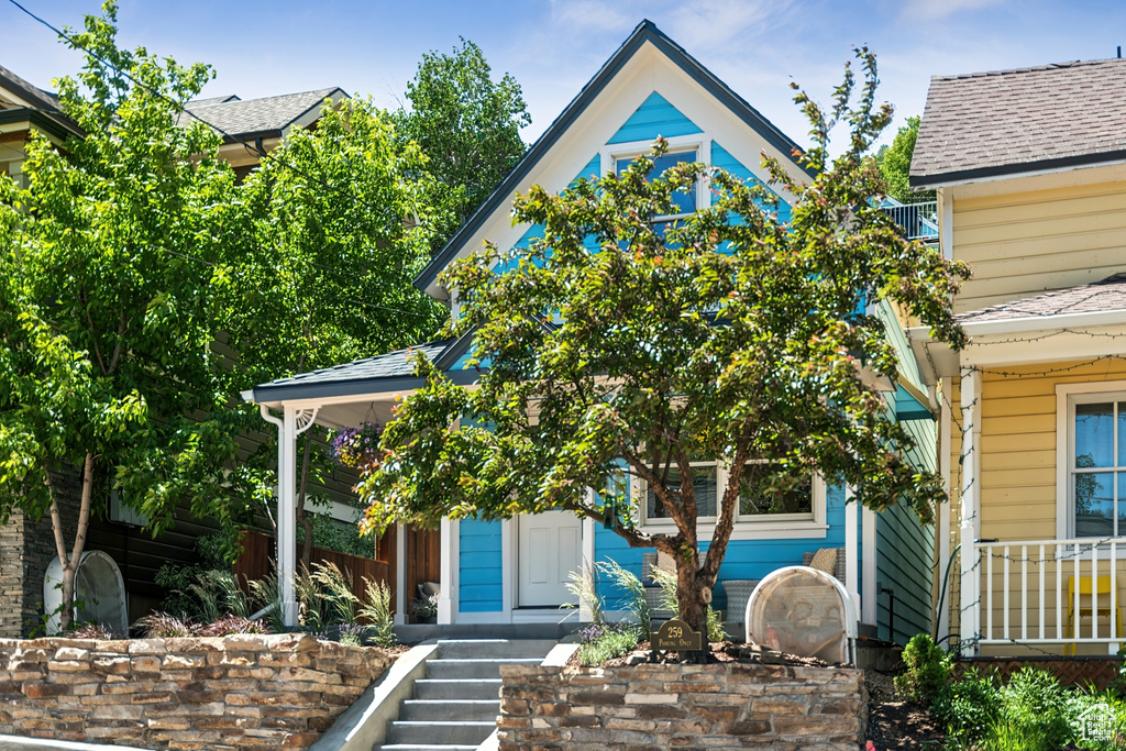 View of front facade featuring roof with shingles