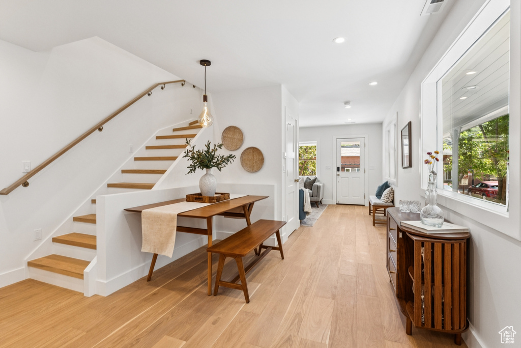Corridor featuring stairway, recessed lighting, and light wood-style flooring