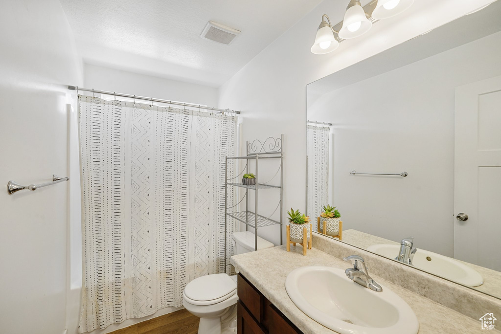 Bathroom with vanity and shower / bath combination with curtain