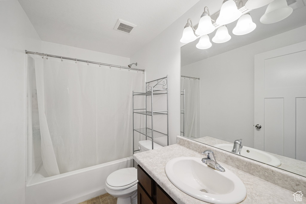 Bathroom featuring vanity and shower / tub combo