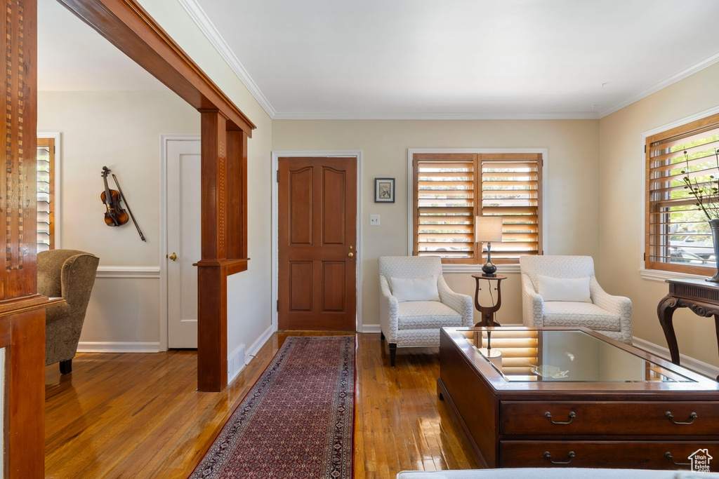 Foyer featuring light wood-style flooring and ornamental molding