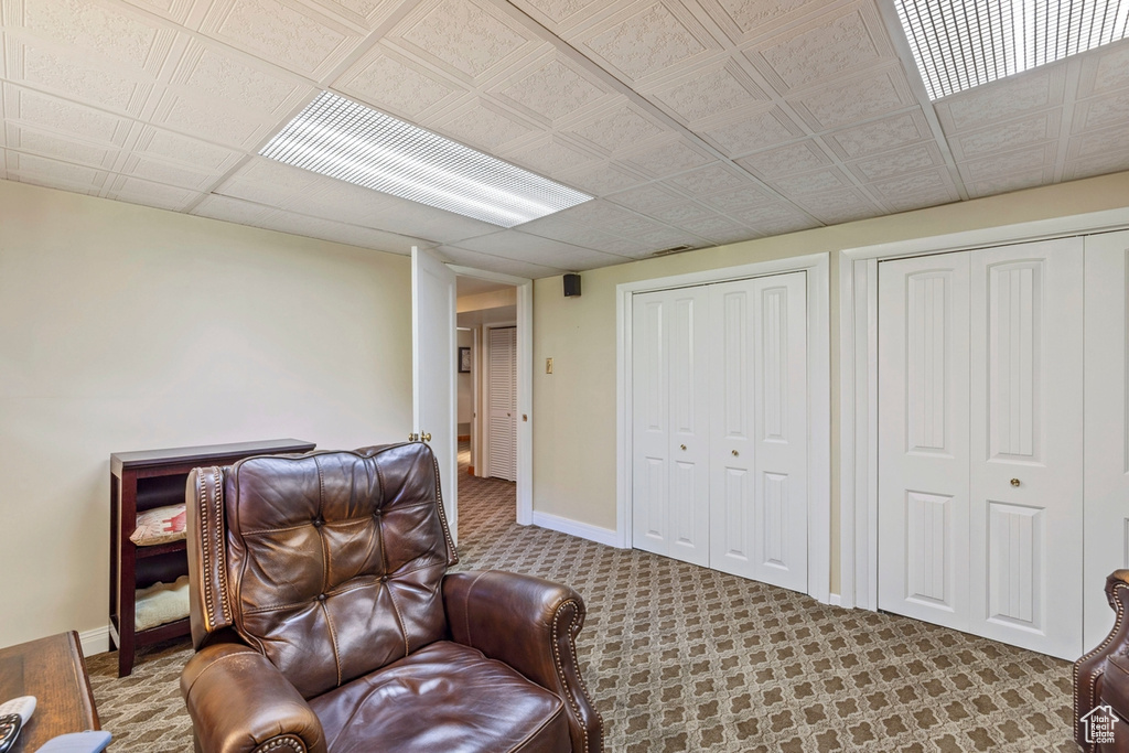 Living area with carpet flooring and baseboards