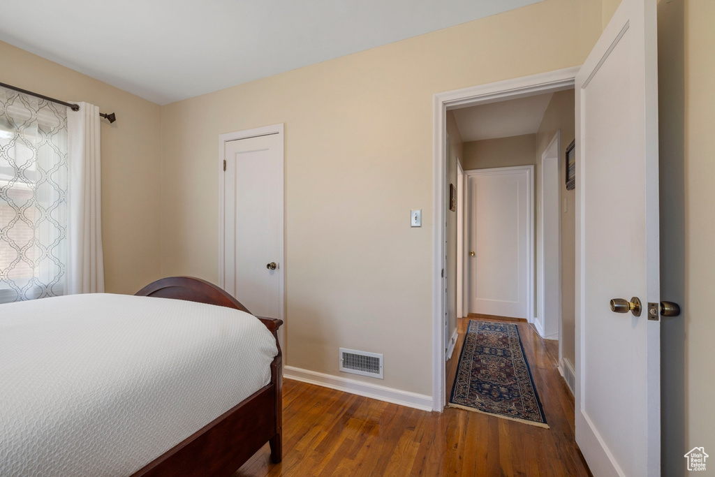 Bedroom featuring baseboards and wood finished floors
