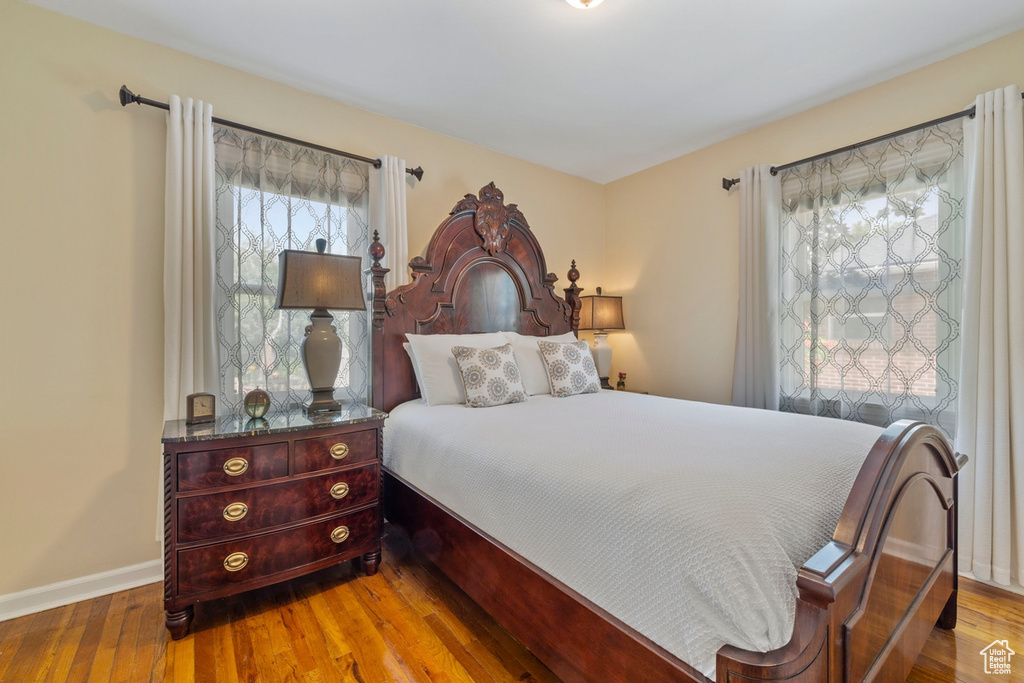 Bedroom featuring wood finished floors and baseboards