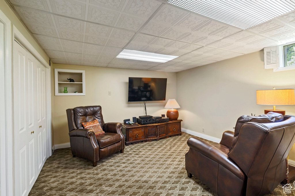 Carpeted living room featuring baseboards