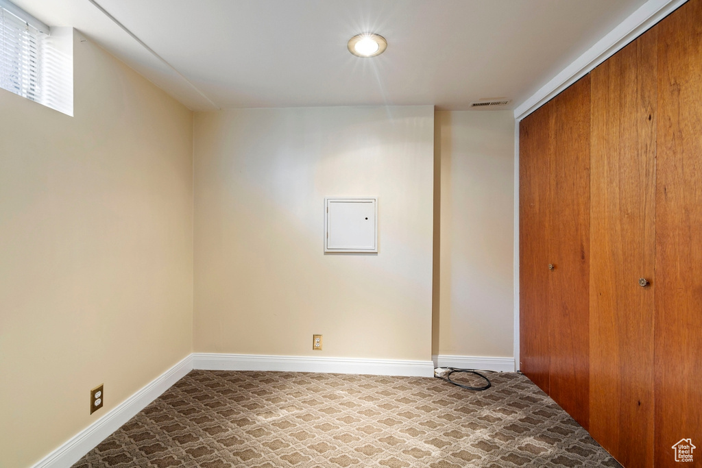 Unfurnished bedroom with a closet, tile patterned floors, and electric panel