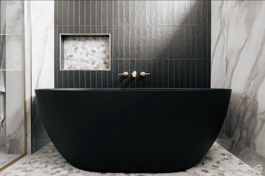 Bathroom with a freestanding tub and a shower