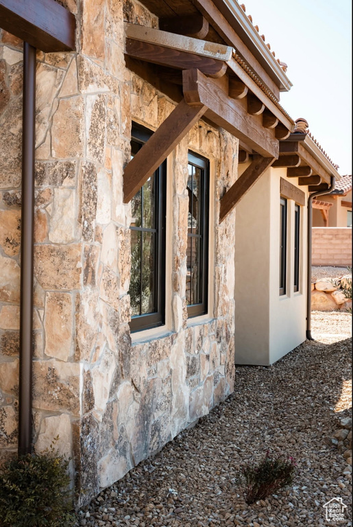 View of property exterior featuring stone siding