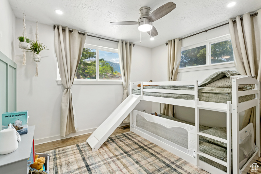 Unfurnished bedroom with recessed lighting, wood finished floors, and a textured ceiling