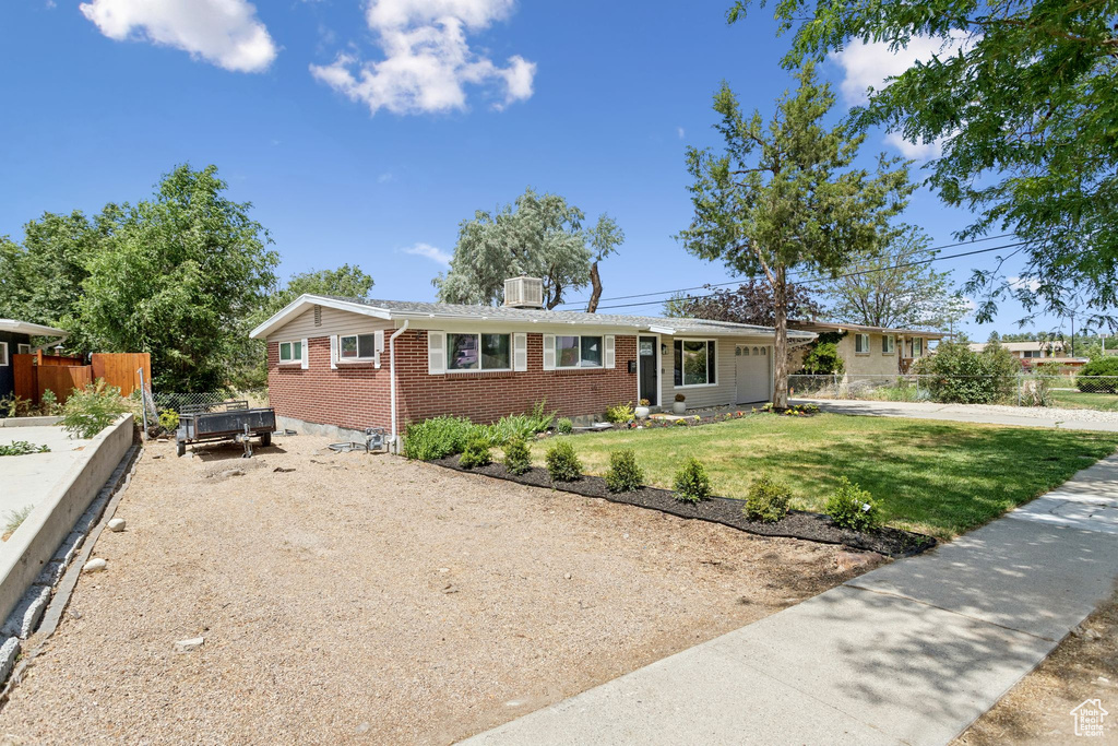 Ranch-style house featuring brick siding