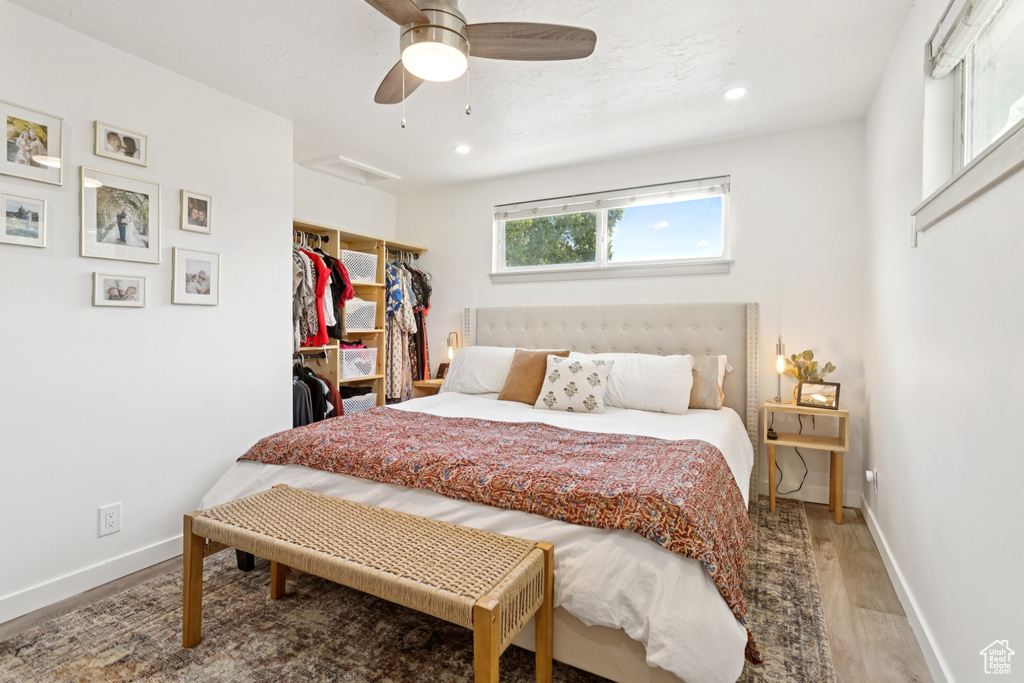 Bedroom featuring wood finished floors, recessed lighting, ceiling fan, and a closet
