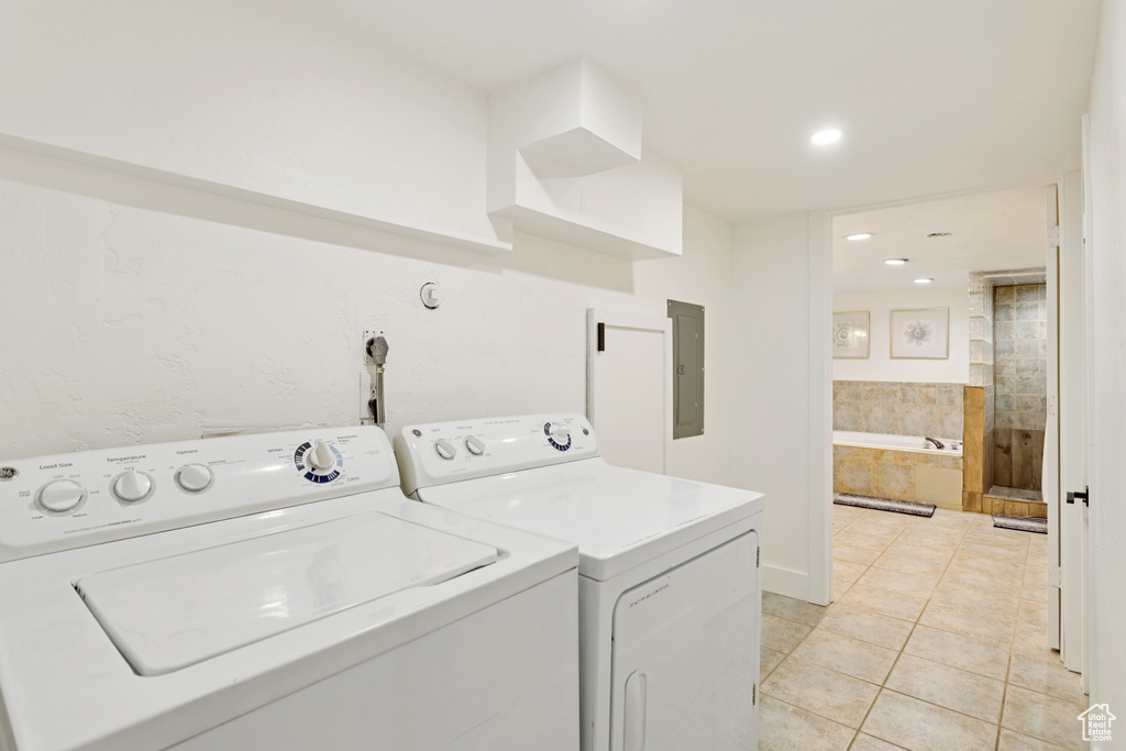 Washroom with electric panel, separate washer and dryer, light tile patterned flooring, and recessed lighting