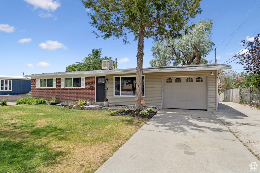 Single story home with an attached garage, concrete driveway, and brick siding