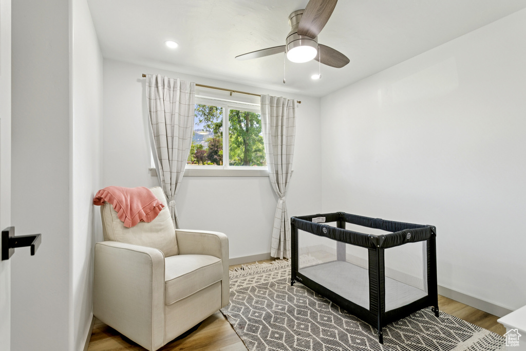 Sitting room featuring wood finished floors, a ceiling fan, and recessed lighting