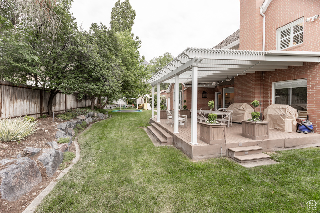 View of yard featuring a pergola and a deck