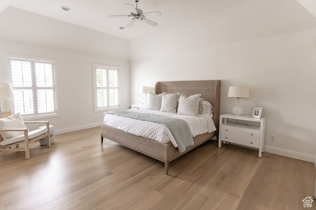 Bedroom featuring lofted ceiling, light wood finished floors, and a ceiling fan