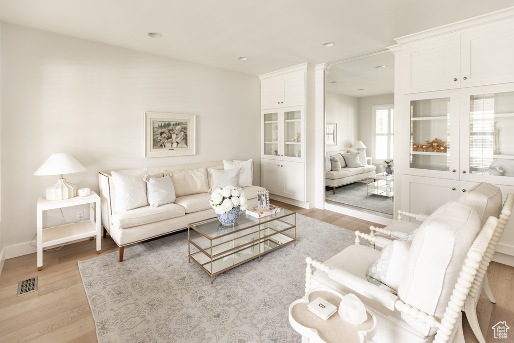 Living room featuring light wood finished floors and recessed lighting
