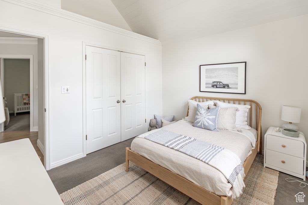 Bedroom featuring lofted ceiling and a closet