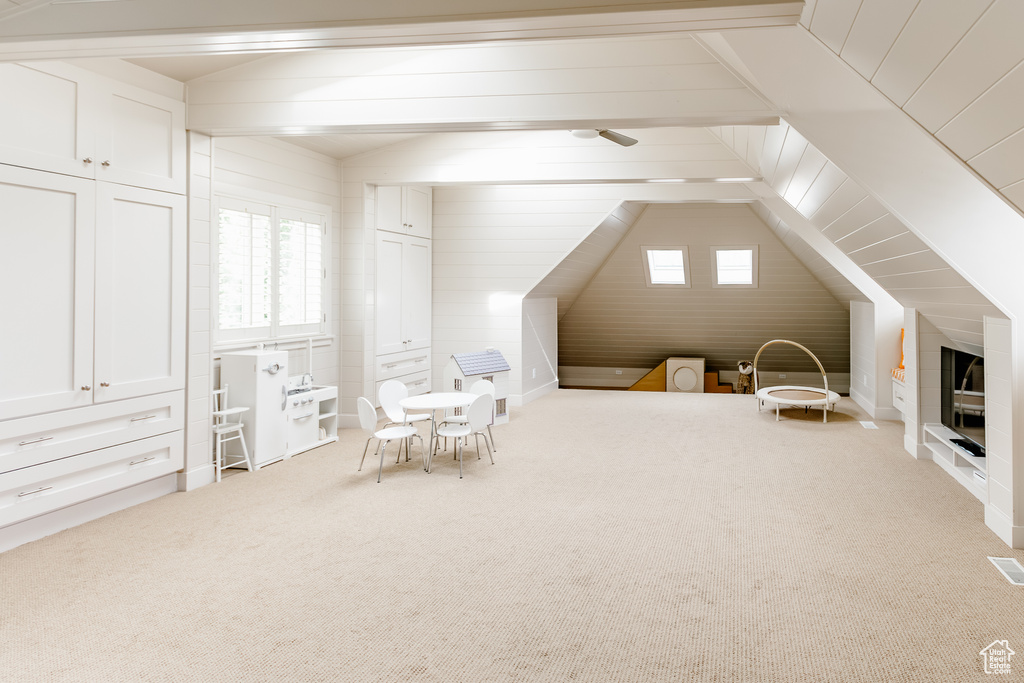 Bonus room with carpet floors and vaulted ceiling