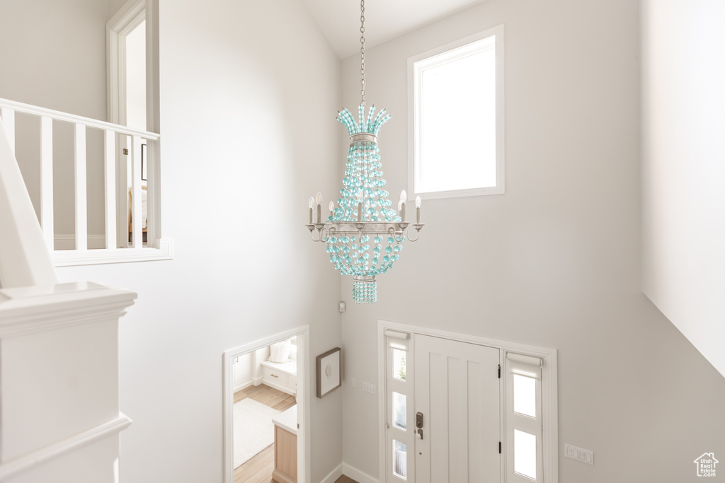 Foyer featuring a chandelier and a towering ceiling