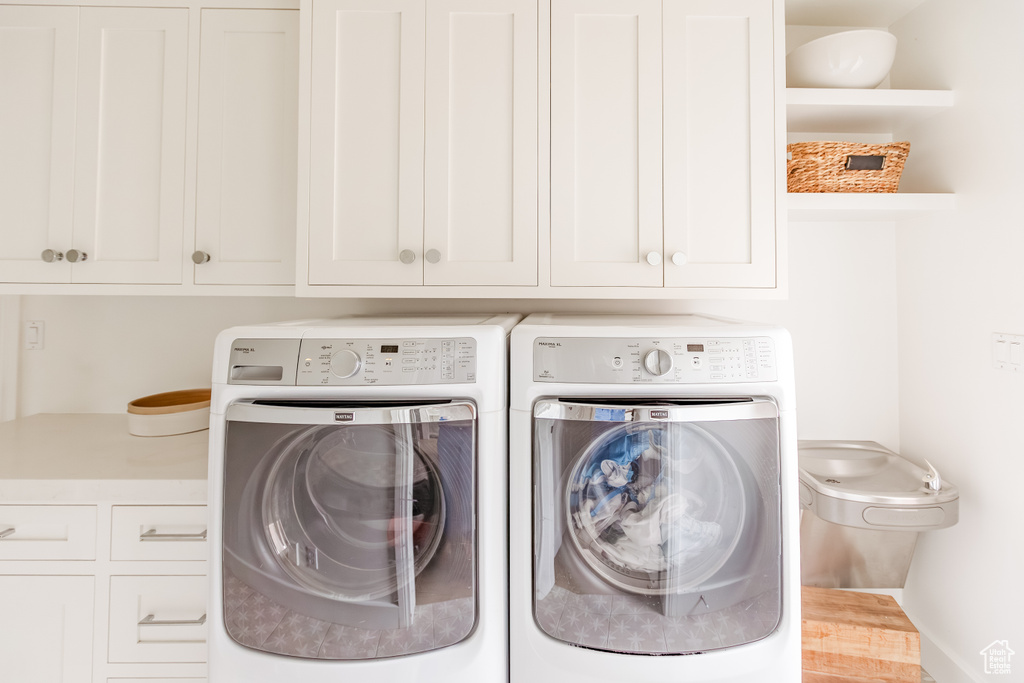 Laundry area featuring cabinet space and washer and dryer