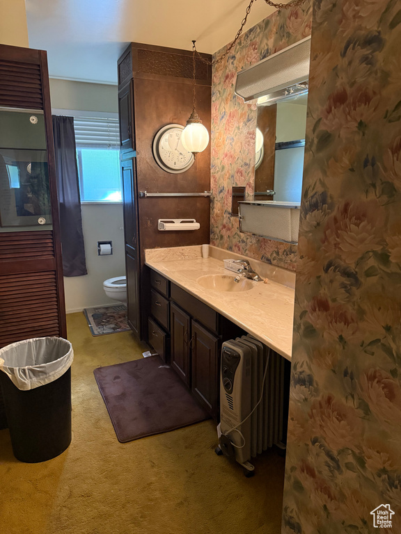 Bathroom featuring vanity and wallpapered walls