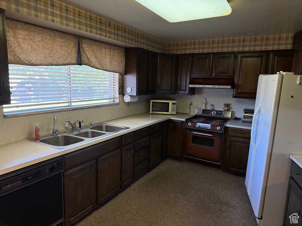 Kitchen featuring range with electric stovetop, black dishwasher, stainless steel microwave, white refrigerator with ice dispenser, and light countertops