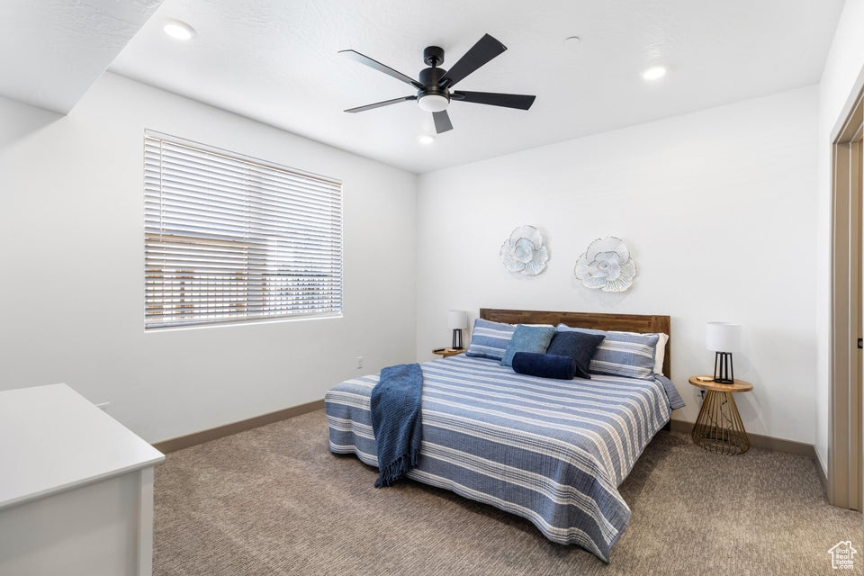 Carpeted bedroom with recessed lighting and ceiling fan