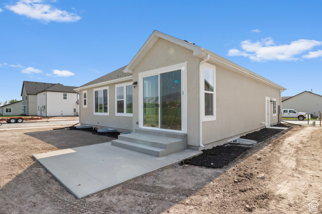 Rear view of property with a patio area and stucco siding