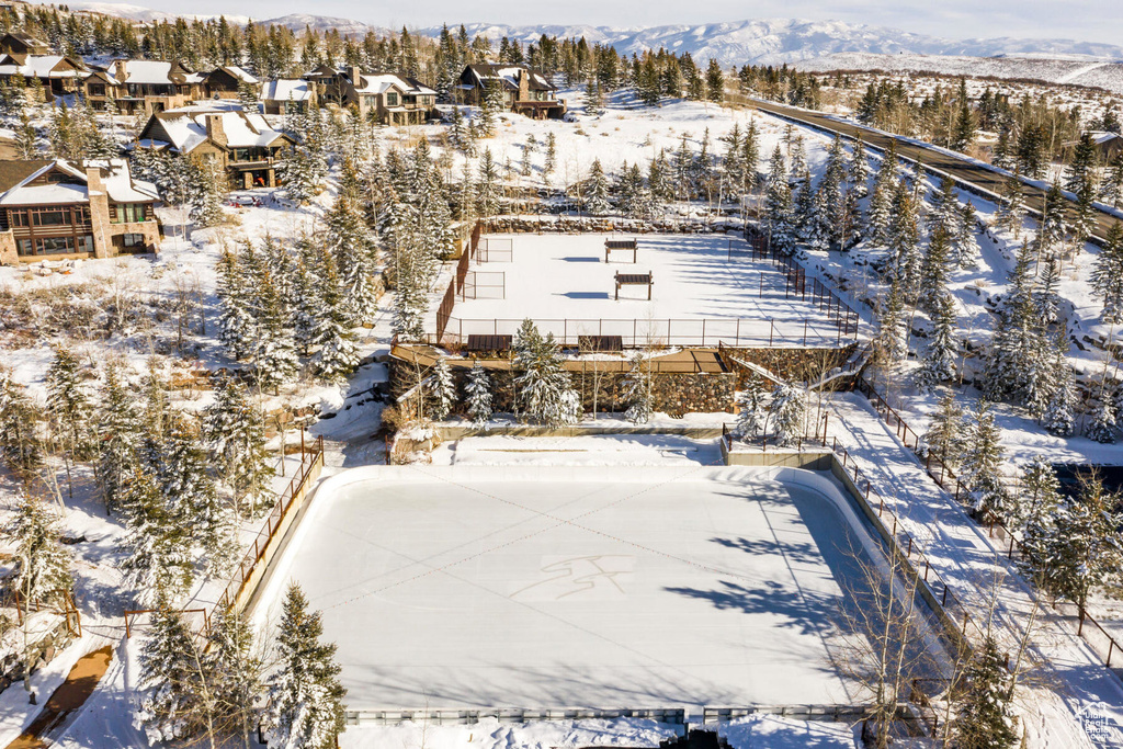 Snowy aerial view with a mountain view and a residential view