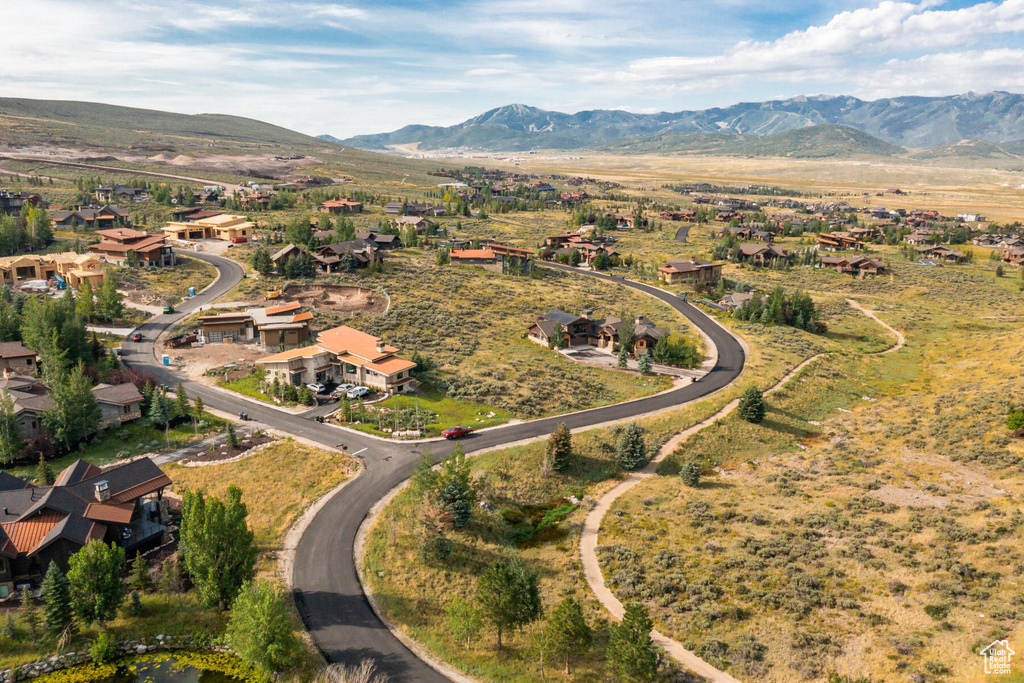 Aerial view of property's location featuring a mountain backdrop